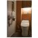 珪藻土の壁面と間接照明で照らされたタンクレストイレ＆手洗い器 サムネイル