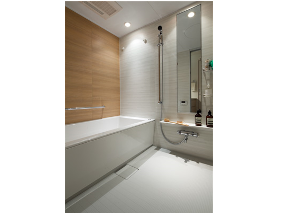 ■ バスルーム・ 優美な形状の浴槽は、半身浴や全身浴などさまざまな入浴スタイルへ対応。壁面には落ち着いた木目調パネルを採用し、優雅なひと時を過ごせる空間に設えています。 イメージ